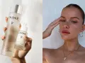 Come applicare il siero viso Caudalie per una pelle radiosa. La mano tiene due flaconi del prodotto, uno più grande e uno con contagocce.
